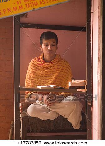 Young man reading a book in India View Large Photo Image Stock Photo - Young man reading a book in India. Fotosearch