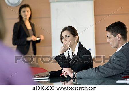 Stock Photograph - Business people at a presentation. Fotosearch