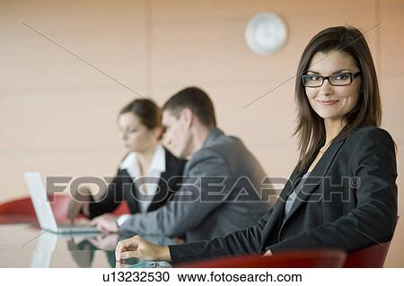 Business people at conference table View Large Photo Image Stock Image - Business people at conference table. Fotosearch