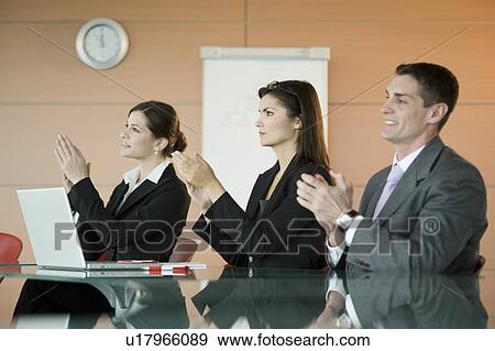 Stock Photo - Business people at presentation clapping. Fotosearch