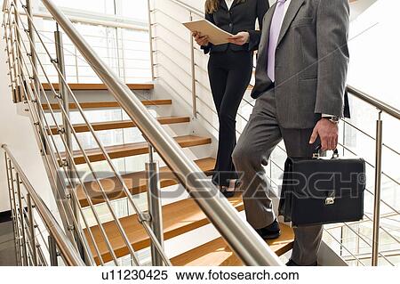 Business people on office staircase View Large Photo Image Stock Photography - Business people on office staircase. Fotosearch