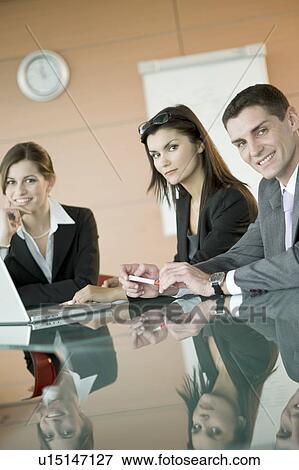 Stock Photo - Business people over laptop. Fotosearch
