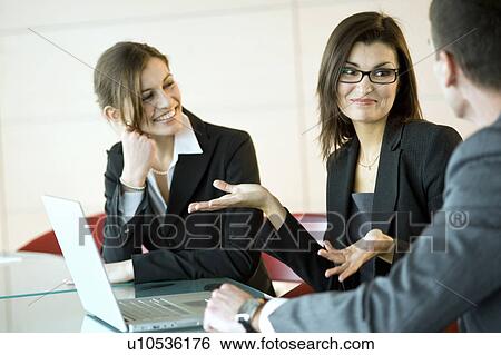 Stock Photograph - Business people over laptop. Fotosearch