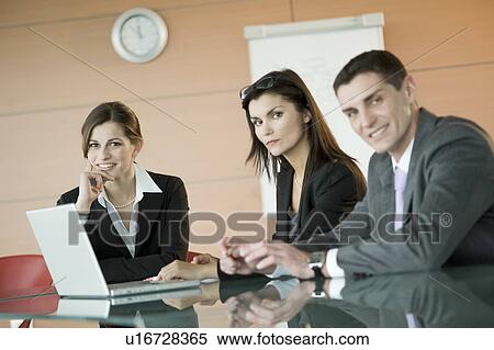 Business people over laptop View Large Photo Image Stock Photography - Business people over laptop. Fotosearch