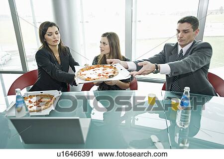 Business people sharing pizza at desk View Large Photo Image Stock Image - Business people sharing pizza at desk. Fotosearch
