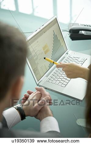 Business people with laptop showing bar chart View Large Photo Image Stock Photo - Business people with laptop showing bar chart. Fotosearch