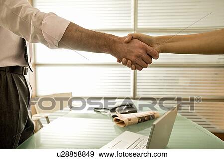 Businessman and businesswoman shaking hands View Large Photo Image Stock Photo - Businessman and businesswoman shaking hands. Fotosearch