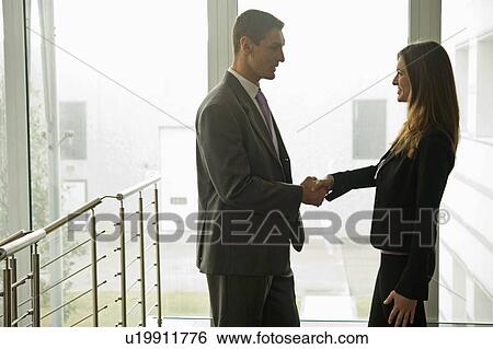 Businessman and businesswoman shaking hands View Large Photo Image Stock Photograph - Businessman and businesswoman shaking hands. Fotosearch
