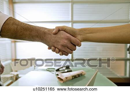 Businessman and businesswoman shaking hands View Large Photo Image Stock Photography - Businessman and businesswoman shaking hands. Fotosearch