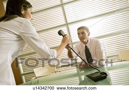 Businessman giving the telephone to businesswoman View Large Photo Image Stock Image - Businessman giving the telephone to businesswoman. Fotosearch