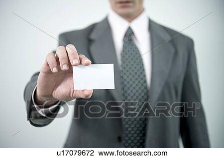 Businessman holding blank business card View Large Photo Image Stock Image - Businessman holding blank business card. Fotosearch