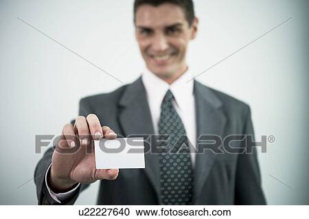 Businessman holding blank business card View Large Photo Image Stock Image - Businessman holding blank business card. Fotosearch