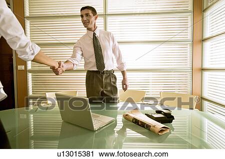 Businessman in office greeting businesswoman View Large Photo Image Stock Image - Businessman in office greeting businesswoman. Fotosearch