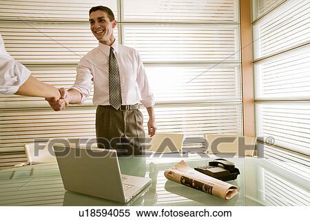 Businessman in office greeting businesswoman View Large Photo Image Stock Photography - Businessman in office greeting businesswoman. Fotosearch