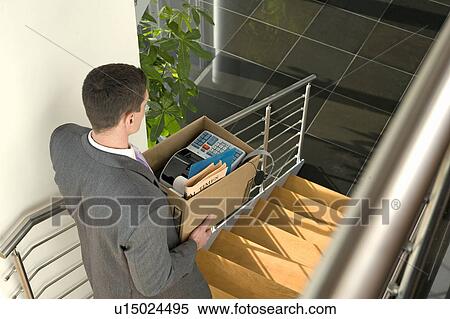 Businessman on office staircase with box of belongings View Large Photo Image Stock Photography - Businessman on office staircase with box of belongings. Fotosearch
