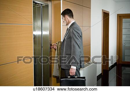 Picture - Businessman waiting for the elevator. Fotosearch