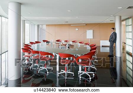 Stock Image - Businessman waiting in conference room. Fotosearch