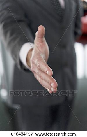 Stock Photo - Businessman's hand out for handshake. Fotosearch