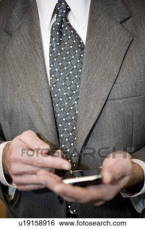 Businessman's hands holding cell phone View Large Photo Image Stock Photograph - Businessman's hands holding cell phone. Fotosearch
