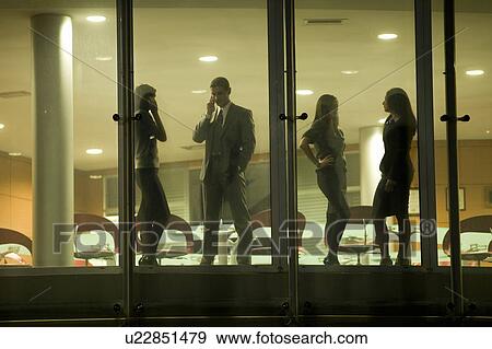 Businessmen and businesswomen in office building View Large Photo Image Stock Photo - Businessmen and businesswomen in office building. Fotosearch