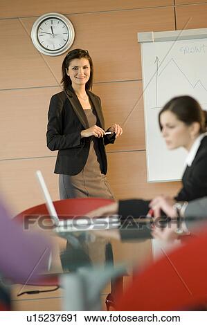 Stock Image - Businesswoman at a presentation. Fotosearch