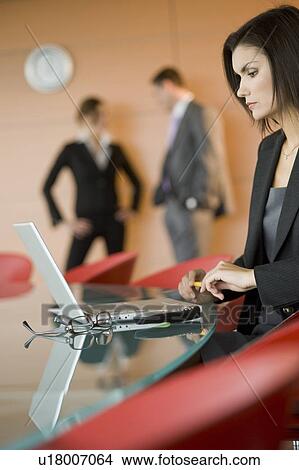 Businesswoman at meeting with laptop View Large Photo Image Picture - Businesswoman at meeting with laptop. Fotosearch