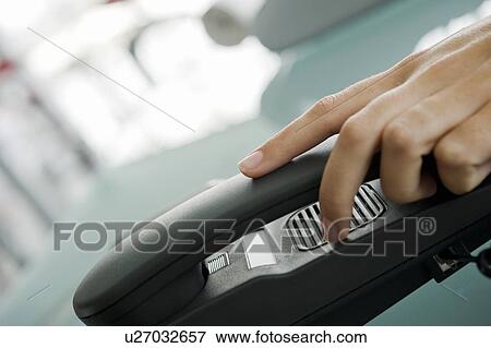 Stock Photo - Closeup of woman's hand on telephone. Fotosearch
