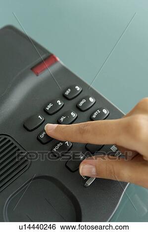Stock Photograph - Closeup of woman's hand telephoning. Fotosearch