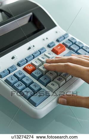 Closeup of woman's hand using calculator View Large Photo Image Picture - Closeup of woman's hand using calculator. Fotosearch