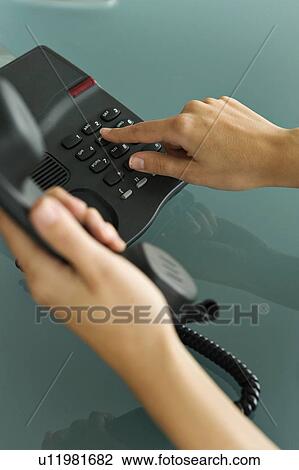 Stock Image - Closeup of woman's hands telephoning. Fotosearch