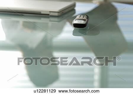 "Desk with laptop, cell phone, and reflection of professional woman with newspaper" View Large Photo Image Stock Photo - "Desk with laptop, cell phone, and reflection of professional woman with newspaper". Fotosearch