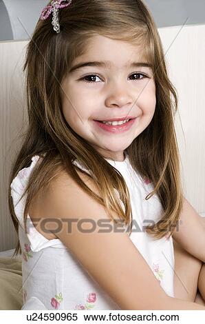 Girl on bed smiling View Large Photo Image Stock Photography - Girl on bed smiling. Fotosearch