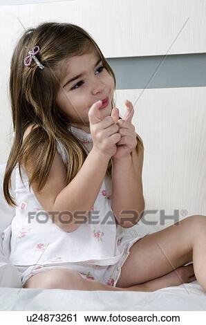 Girl sitting on bed View Large Photo Image Stock Image - Girl sitting on bed. Fotosearch