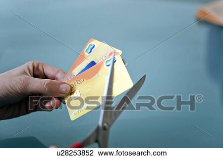 Hands cutting credit cards with scissors View Large Photo Image Stock Image - Hands cutting credit cards with scissors. Fotosearch