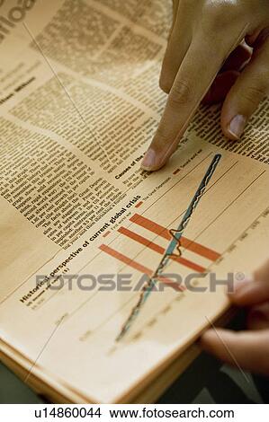 Hands holding newspaper with chart analyzing financial crisis View Large Photo Image Picture - Hands holding newspaper with chart analyzing financial crisis. Fotosearch