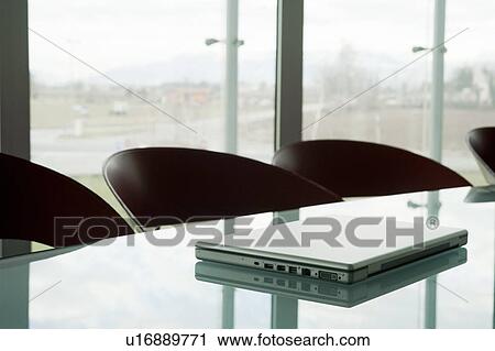 Stock Image - Laptop on conference table. Fotosearch