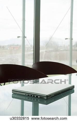 Stock Photography - Laptop on conference table. Fotosearch