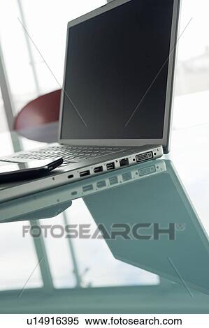 Laptop with cell phone on conference table View Large Photo Image Stock Photography - Laptop with cell phone on conference table. Fotosearch