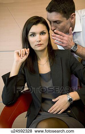 Office worker whispering in co-worker's ear View Large Photo Image Stock Photo - Office worker whispering in co-worker's ear. Fotosearch