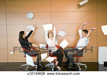 Office workers throwing documents up in the air View Large Photo Image Stock Photo - Office workers throwing documents up in the air. Fotosearch