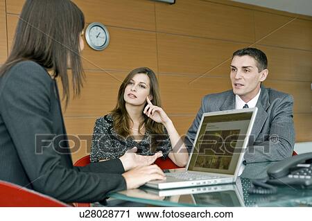 Stock Image - Professional woman meeting with couple. Fotosearch