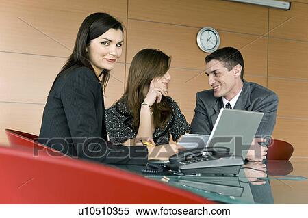 Professional woman with document and smiling couple View Large Photo Image Stock Photography - Professional woman with document and smiling couple. Fotosearch
