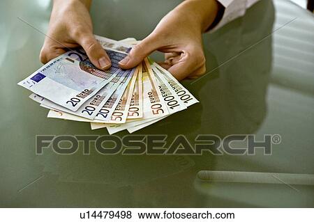 Woman's hands holding euro bills View Large Photo Image Stock Photo - Woman's hands holding euro bills. Fotosearch