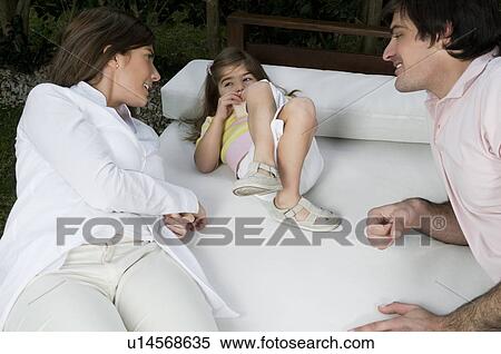 Young couple and girl lying on outdoor couch View Large Photo Image Stock Photography - Young couple and girl lying on outdoor couch. Fotosearch