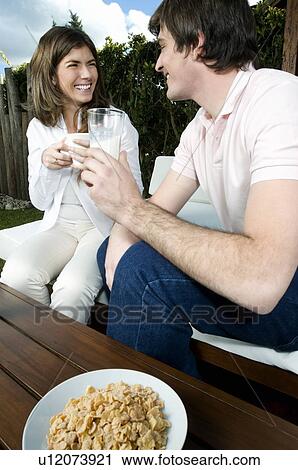 Young couple having breakfast outdoors View Large Photo Image Stock Image - Young couple having breakfast outdoors. Fotosearch