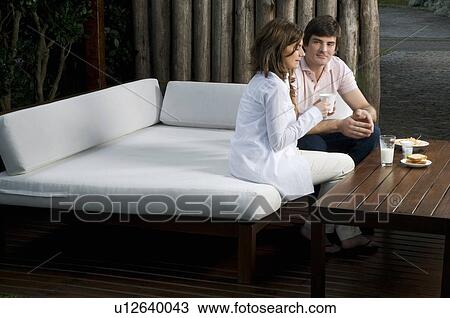 Young couple having breakfast outdoors View Large Photo Image Stock Image - Young couple having breakfast outdoors. Fotosearch
