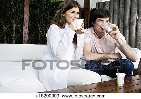 Stock Photo - Young couple having breakfast outdoors. Fotosearch