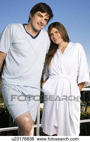 Young couple in pajamas and bathrobe on balcony View Large Photo Image Stock Photo - Young couple in pajamas and bathrobe on balcony. Fotosearch