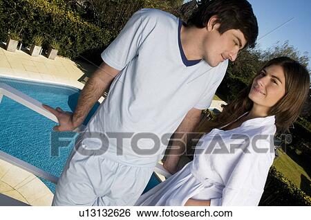 Young couple in pajamas and bathrobe on balcony View Large Photo Image Stock Photograph - Young couple in pajamas and bathrobe on balcony. Fotosearch