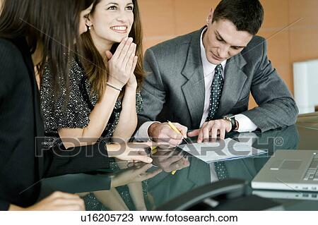 "Young man signing document, professional woman pointing" View Large Photo Image Stock Image - "Young man signing document, professional woman pointing". Fotosearch